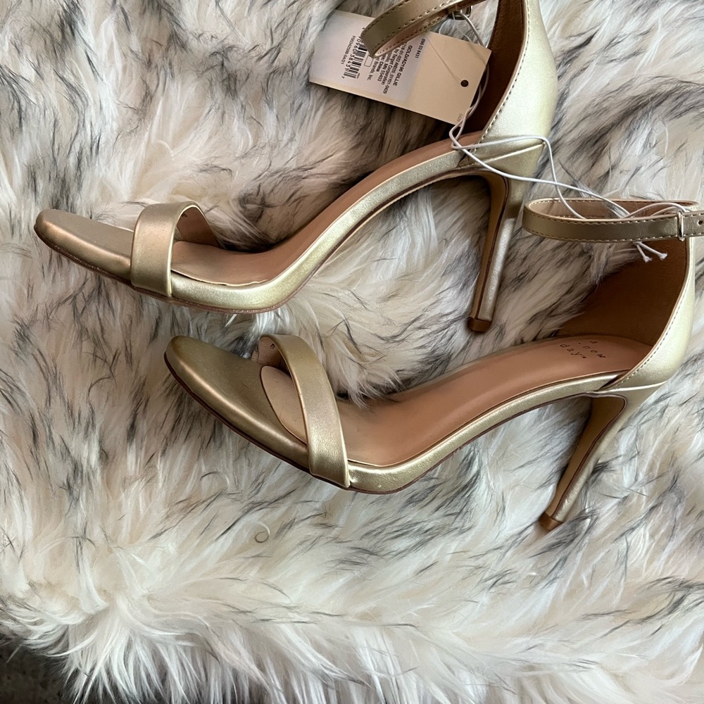 Brand new muted gold faux leather ankle strap sandal.
